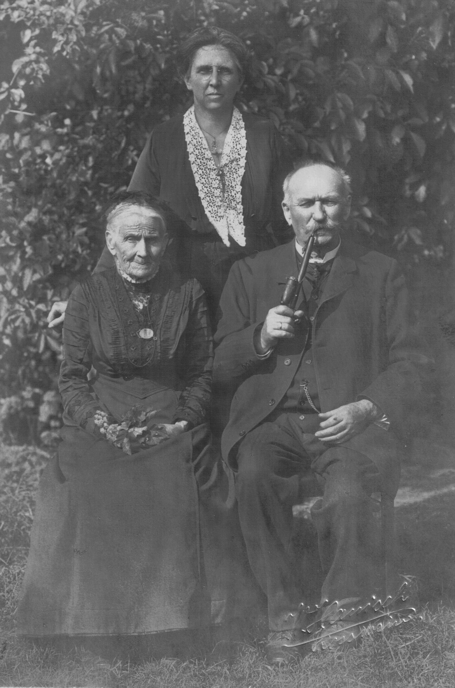 woman standing behind seated couple